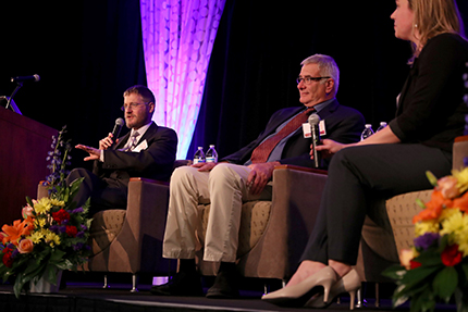 U-M economists Donald Grimes, center, and Gabriel Ehrlich answer questions from the audience after presenting the county economic outlook data March 28 at the Washtenaw Economic Club luncheon.