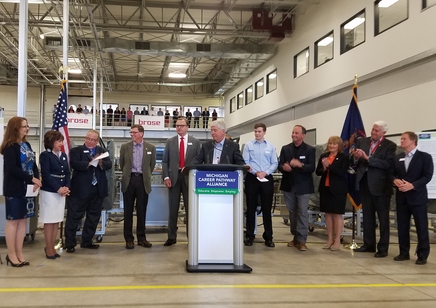 Brend an Prebo Dr. Rose B. Bellanca (second from left) joins Gov. Rick Snyder (center) on stage with (from left to right) Clare Brisson (Chippewa Valley Schools), Brian Whiston, Roger Curtis, Michael Brosseau (Brose) Lee Graham (IUOE 324), Barb Land (Square One Network), Sen.Marty Knollenberg, and Sen. Ken Horn.