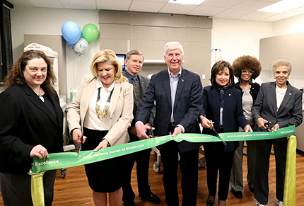 Cutting the ribbon on the WCC nursing labs were (from left) Trustee Christina Fleming, Dean of Health Services Dr. Valerie Greaves, Trustee Bill Milliken Jr., Governor RIck Snyder, WCC President Dr. Rose B. Bellanca, Trustee Angela Davis and Trustee Diana McKnight-Morton.