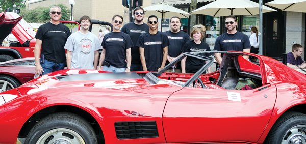 Washtenaw Community College Auto Body Repair Program instructor and advisor Scott Malnar (far left) poses alongside a 1971 Stingray Corvette with students (from left to right) Steven Salah, Tom Holevinski, Jason Bazylewicz, Trey Trotter, Liam Clark, Aideen Quinn and Jason Mosquera.