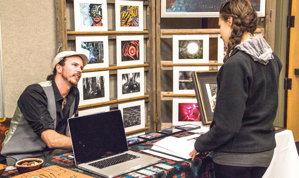 Benjamin Bear, a 26-year-old photography student from Adrian, receives praise from fellow photogra-phy student Jessica Dorow, also 26, from Ann Arbor. Gray Bancroft | Washtenaw Voice