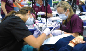 Jodi Neuman (right), WCC Clinical Instructor, volunteers her time at the Michigan Dental Association Mission of Mercy Event.